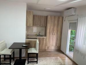 a kitchen with a table and chairs in a room at Centar Bruno in Novi Pazar