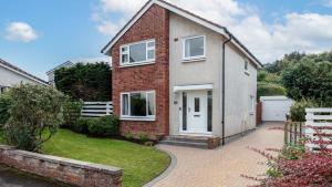 una casa de ladrillo con puerta blanca y entrada en Leeward House - Donnini Apartments, en Ayr