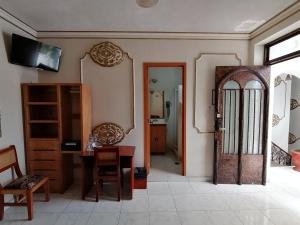 a room with a door and a table and a mirror at Casa de la Luna in Mexico City