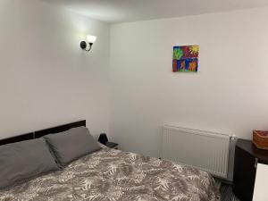 a bedroom with a bed and a picture on the wall at Ski View Studio - near the ski slopes in Azuga