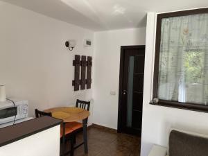 a small kitchen with a table and a microwave at Ski View Studio - near the ski slopes in Azuga