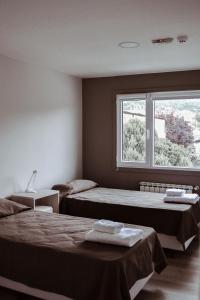Katil atau katil-katil dalam bilik di Gente del Sur - Guiraldes