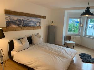 a bedroom with a bed with white sheets and pillows at Bergsteiger Schlafplätze mit Parkplatz in Haslach