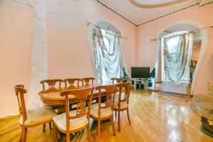 a dining room with a table and chairs at Baku Nizami Street Triplex 4 bedroom in Baku
