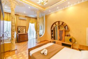 a bedroom with a large bed in a room at Baku Nizami Street Triplex 4 bedroom in Baku