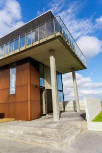 a building with a balcony on top of it at Converted Water Tower in Grindavík