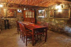 a dining room with a wooden table and chairs at Agroturystka u Basi in Pietrzykowice
