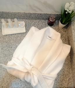 a white robe with a bow on a counter at Adamas House Hotel Boutique in Quito +161 photos
