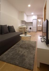 a living room with a couch and a table at APARTAMENTO FRANJA 50 Gastromaar in A Coruña