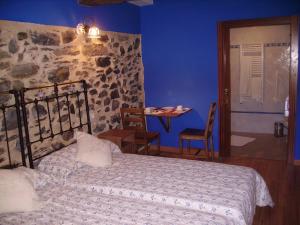 En eller flere senge i et værelse på Casa Rural Pikatzaenea