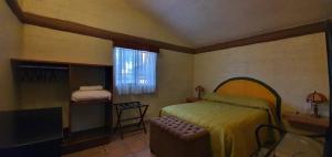 a bedroom with a bed and a chair and a window at Parque Girasoles Balneario & Cabañas in San Francisco del Rincón +65 photos