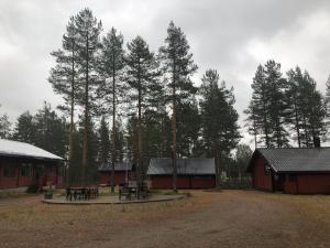 a group of buildings with a picnic table and trees at Rena HOSTEL EINARA in Rena