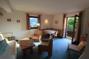 a living room with a couch and a table at Ferienwohnungen Fiala-Köfer in Pörtschach am Wörthersee