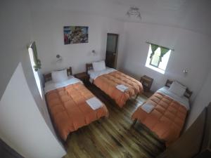 an overhead view of a bedroom with four beds at Tucan Hostel in Cusco