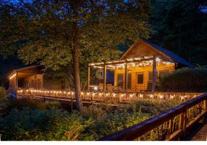 a log cabin with lights on the front of it at Mount Mitchell Eco Retreat in Busick
