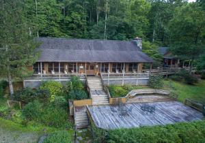an aerial view of a log house with a porch at Mount Mitchell Eco Retreat in Busick