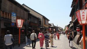 a group of people walking down a street at Kyoto Inn Gion The Second in Kyoto