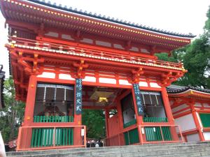 a red building with a balcony in front of it at Kyoto Inn Gion The Second in Kyoto