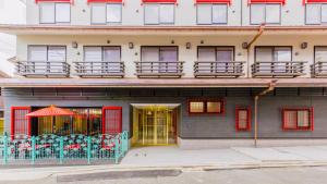 a building with red doors and a balcony at Kyoto Inn Gion The Second in Kyoto