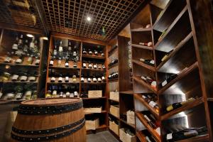 a wine cellar with a barrel and shelves of wine bottles at Phi Phi CoCo Beach Resort in Phi Phi Islands
