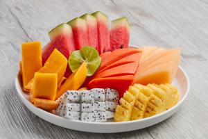 a plate of fruit and cheese and crackers and vegetables at Phi Phi CoCo Beach Resort in Phi Phi Islands