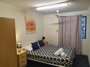 a bedroom with a large bed and a large window at Perth City Apartment Hotel in Perth