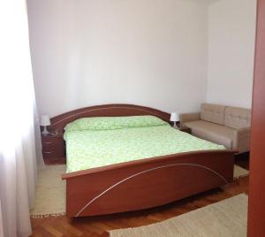 a bedroom with a bed and a couch at Accommodation Vitalio in Umag