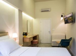 A bed or beds in a room at Athena hotel