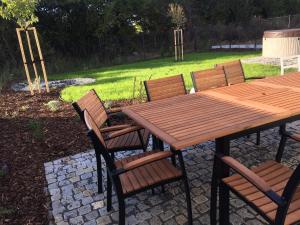 a wooden table and chairs on a patio at Prázdninový dům Mikulov in Mikulov