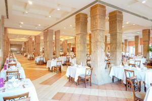 a dining room with white tables and chairs at Charmillion Sea Life Resort in Sharm El Sheikh