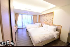 Postel nebo postele na pokoji v ubytování Shang Shan Ting Chao Hotel