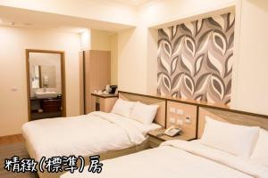 Postel nebo postele na pokoji v ubytování Shang Shan Ting Chao Hotel