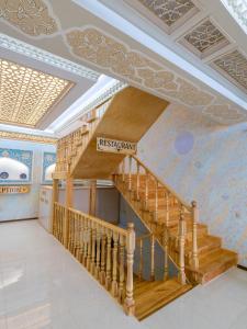 a staircase in a building with a mural on the wall at Grand Vizir Hotel in Khiva