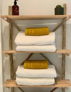a stack of towels on a wooden shelf at Maju in Antwerp