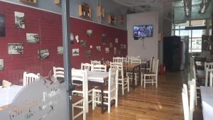 a dining room with white tables and white chairs at Home Sweet Home 3 - Guest House in Tirana
