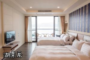 Postel nebo postele na pokoji v ubytování Shang Shan Ting Chao Hotel