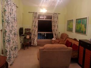 a living room with a couch and a television at River side apartment in Cavelossim