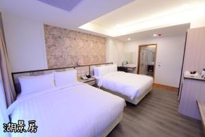 Postel nebo postele na pokoji v ubytování Shang Shan Ting Chao Hotel