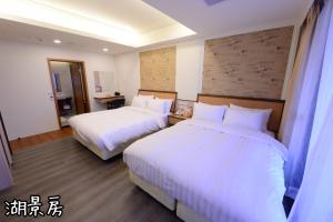 Postel nebo postele na pokoji v ubytování Shang Shan Ting Chao Hotel