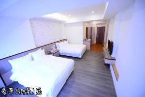 Postel nebo postele na pokoji v ubytování Shang Shan Ting Chao Hotel