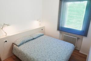Postelja oz. postelje v sobi nastanitve Fioralpino Apartments