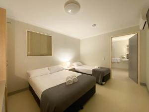 a hotel room with two beds and a bathroom at Lake Tyrrell Accommodation LTA in Sea Lake