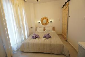 a bedroom with a bed with a mirror and two shoes at "Del Sole" Spa Apartment in Serres