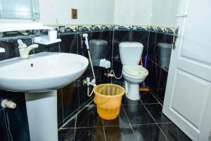 a bathroom with a sink and a toilet at Clifton Rezidor in Karachi +24 photos