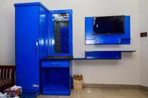 a blue cabinet with a tv in a room at Clifton Rezidor in Karachi