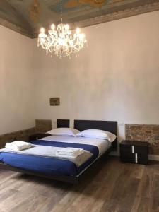 a bedroom with a large bed and a chandelier at Bellavista Lux Ground Floor Apt in Florence