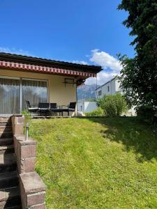 a backyard of a house with a picnic table at Luxury House with big garden and mountain view ( 3 bedrooms) in Haag