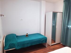 un piccolo giocattolo seduto su un letto in una stanza di Apartment Neretva a Čapljina