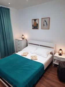 a bedroom with a large bed with a green blanket at Apartment Neretva in Čapljina