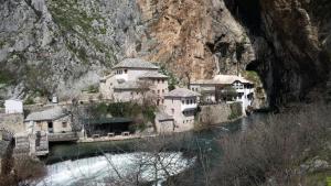 a group of buildings on the side of a mountain at Apartment Neretva in Čapljina